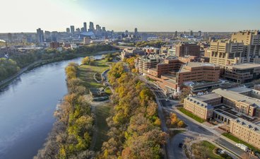 Aerial view of U of M Minneapolis campus, Mississippi River, and downtown Minneapolis.
