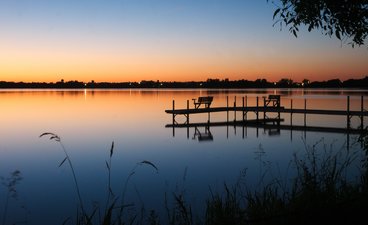 Wooden dock on a lake at sunset